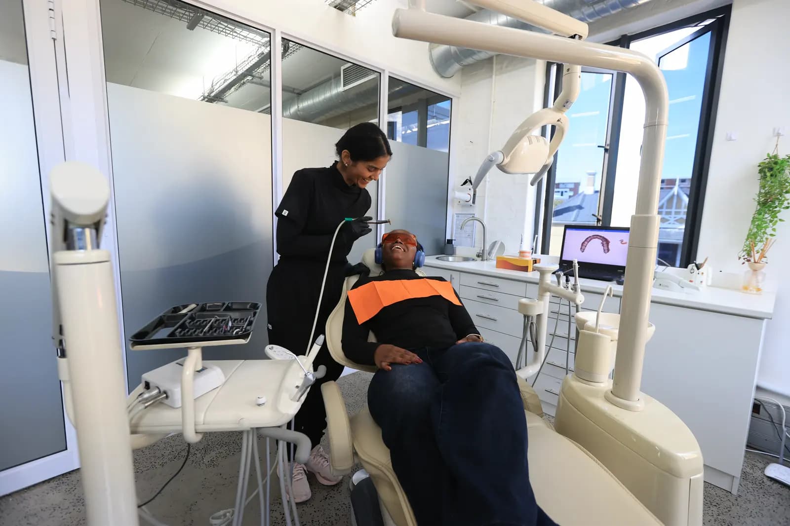 A dentist with a patient in the chair at a Mia practice