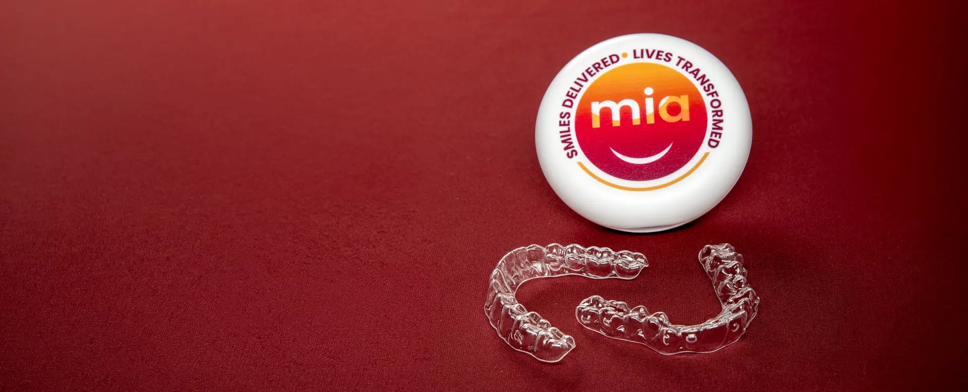 Maroon banner of a Mia case and clear aligner trays
