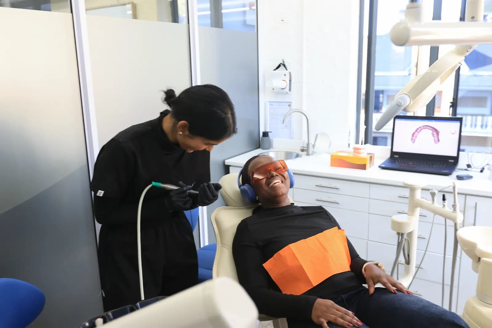 Mia dentist with a laughing patient