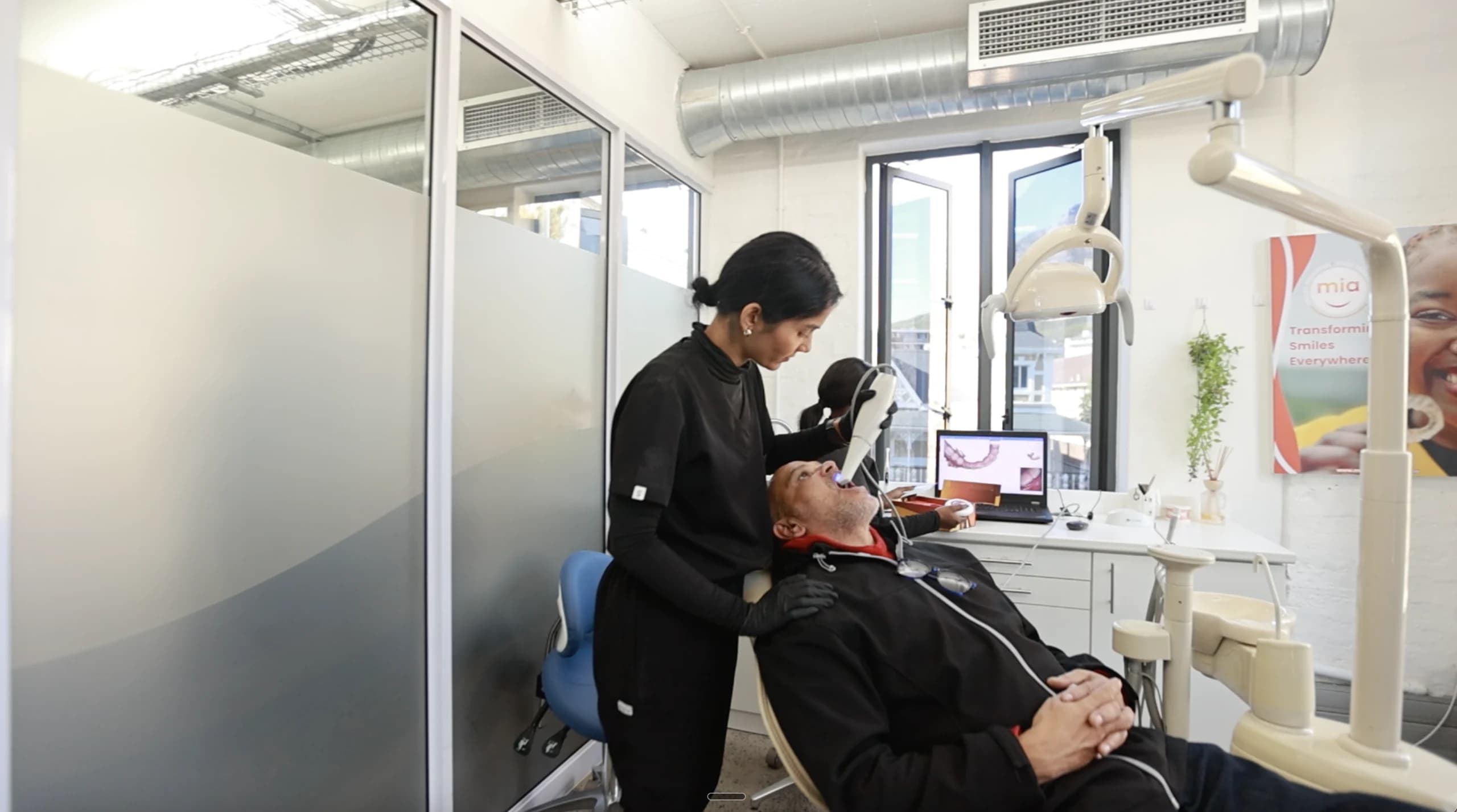 A Mia dentist treating a patient