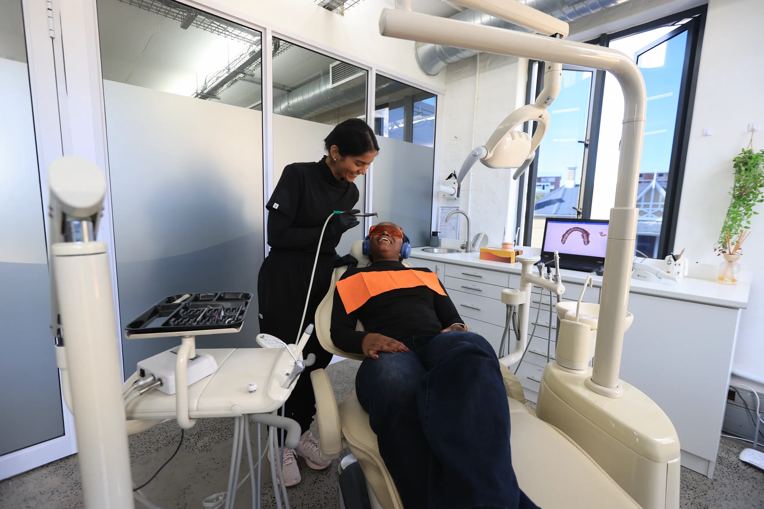 A patient in a dental chair with a Mia dentist