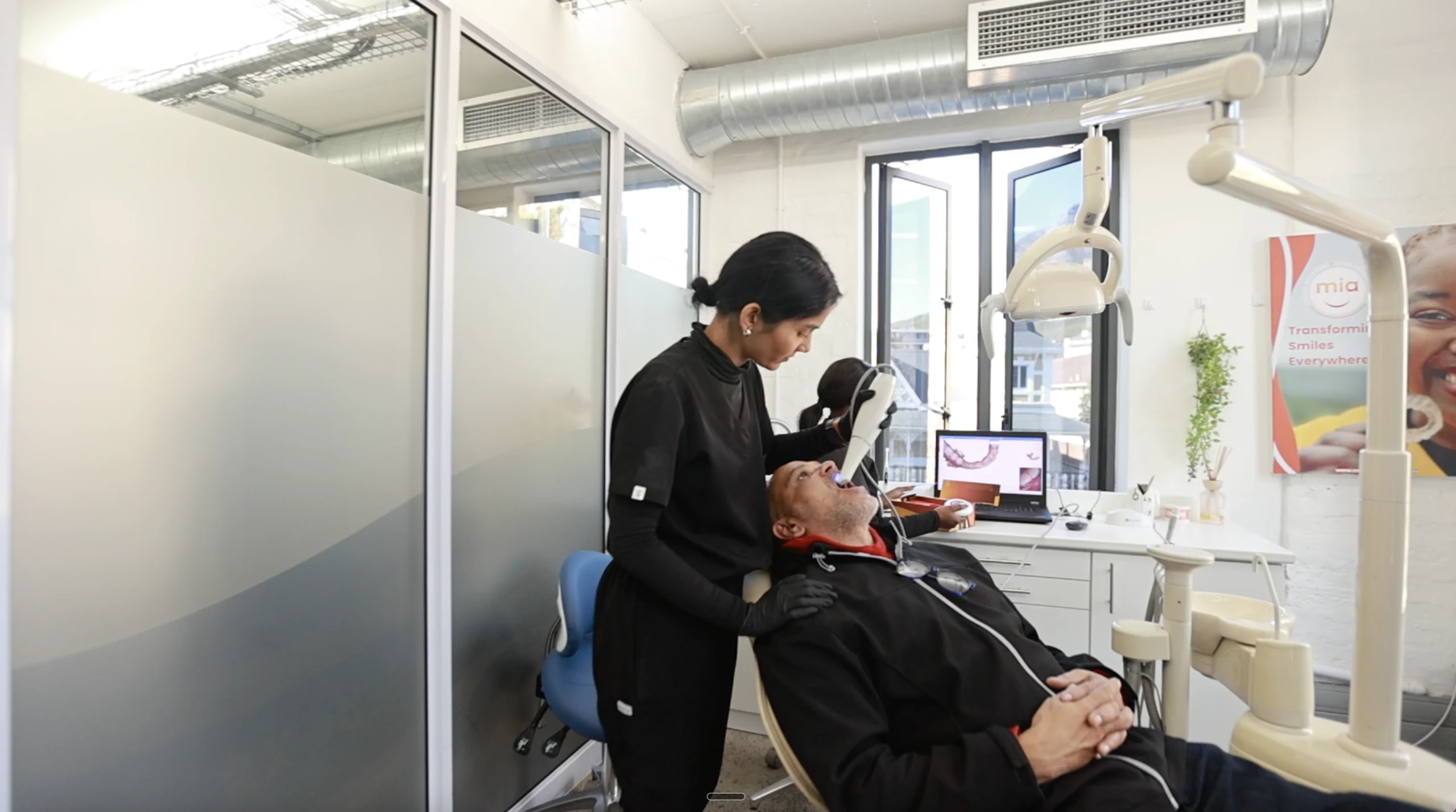 A Mia dentist treating a patient in a fixed practice surgery